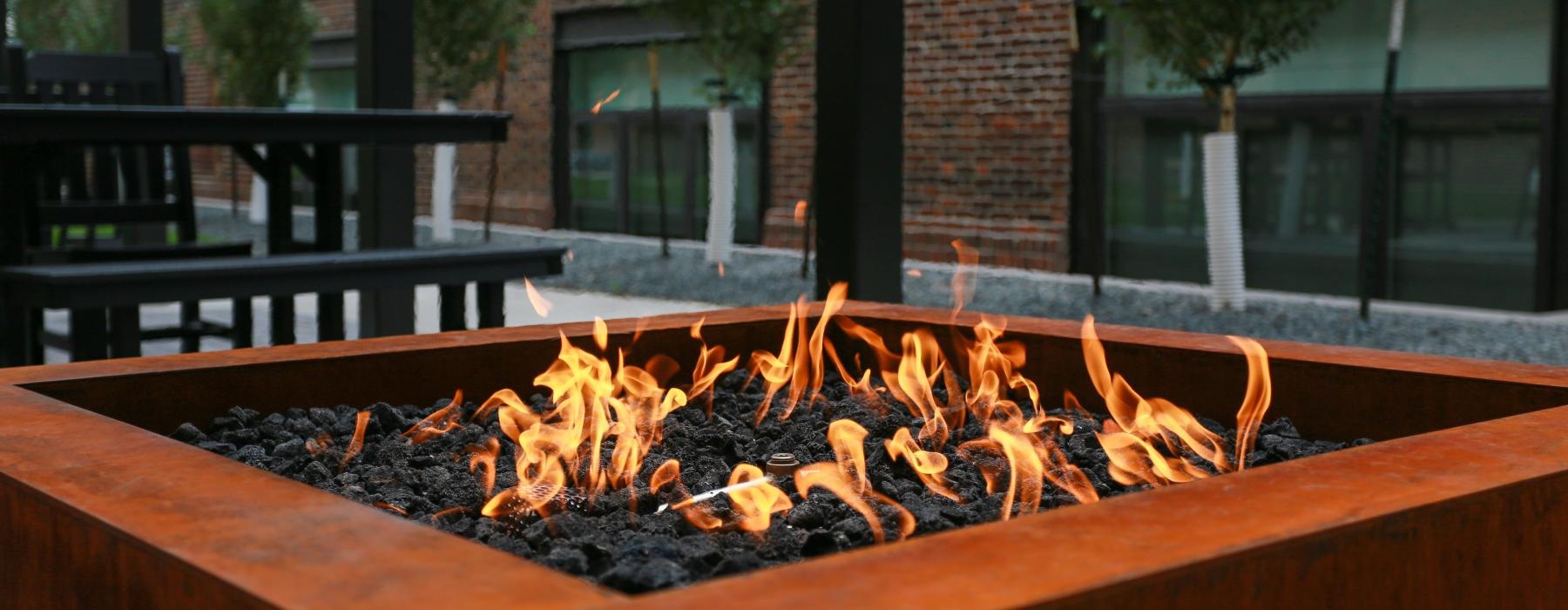 a large fire pit and trees